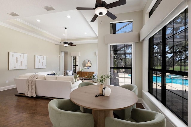 7532 Greystone St, Lakewood Ranch, FL 34202 - dining area with a ceiling fan, ornamental molding, dark wood-type flooring, baseboards, and a raised ceiling