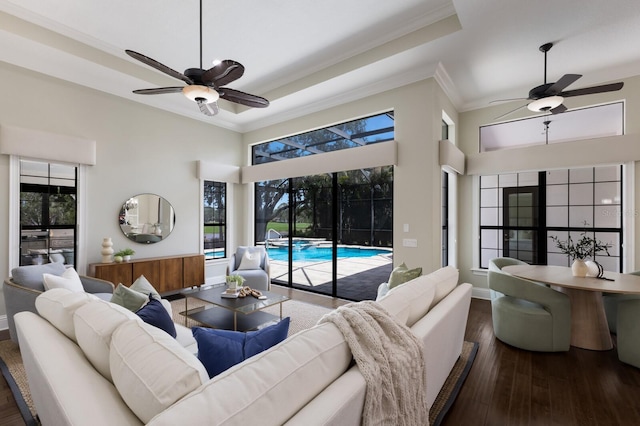 7532 Greystone St, Lakewood Ranch, FL 34202 - living area featuring ceiling fan, crown molding, hardwood / wood-style floors, a towering ceiling, and a sunroom