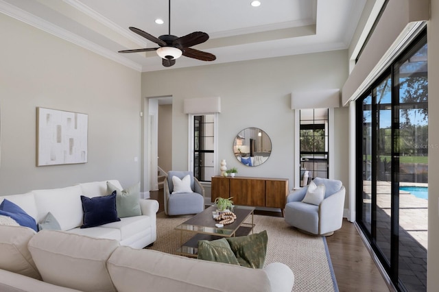 7532 Greystone St, Lakewood Ranch, FL 34202 - living room featuring wood finished floors, ceiling fan, ornamental molding, recessed lighting, and a raised ceiling