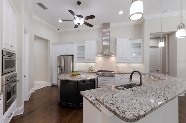 7532 Greystone St, Lakewood Ranch, FL 34202 - kitchen featuring a sink, a center island with sink, wall chimney exhaust hood, appliances with stainless steel finishes, and ceiling fan