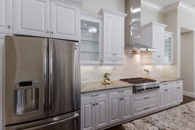 7532 Greystone St, Lakewood Ranch, FL 34202 - kitchen with stainless steel appliances, wall chimney exhaust hood, white cabinets, crown molding, and backsplash