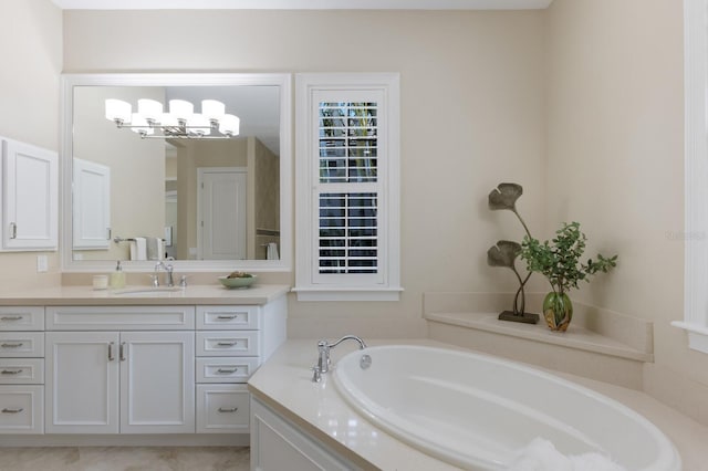 7532 Greystone St, Lakewood Ranch, FL 34202 - bathroom featuring vanity, a garden tub, and a chandelier