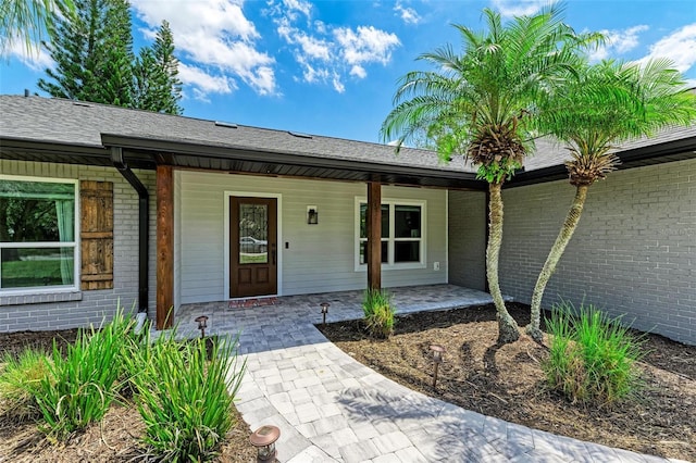 1103 134th St E, Bradenton, FL 34212 - doorway to property with brick siding and a porch