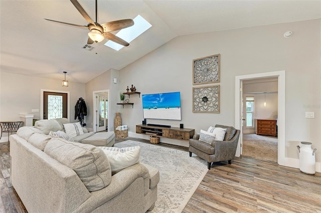 1103 134th St E, Bradenton, FL 34212 - living area featuring a skylight, wood finished floors, ceiling fan, high vaulted ceiling, and baseboards