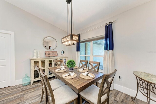 1103 134th St E, Bradenton, FL 34212 - dining room with baseboards, wood finished floors, and a chandelier