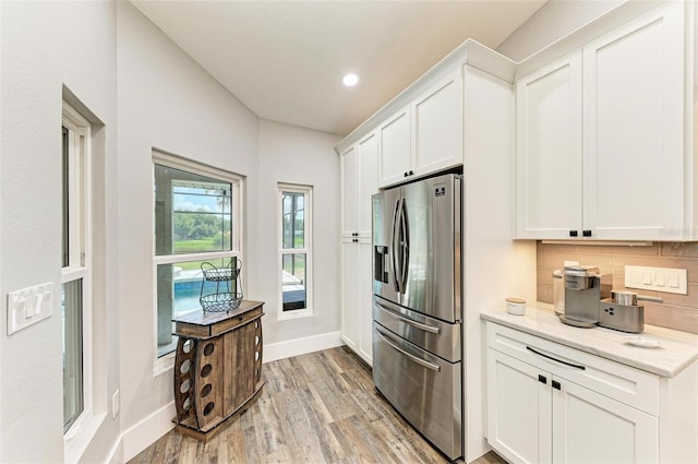1103 134th St E, Bradenton, FL 34212 - kitchen with stainless steel fridge with ice dispenser, light wood finished floors, baseboards, tasteful backsplash, and recessed lighting