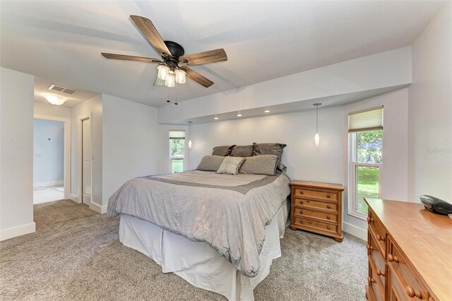 1103 134th St E, Bradenton, FL 34212 - bedroom featuring light colored carpet, multiple windows, baseboards, and ceiling fan