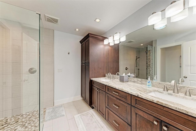 1103 134th St E, Bradenton, FL 34212 - full bathroom featuring a stall shower, tile patterned flooring, double vanity, and baseboards