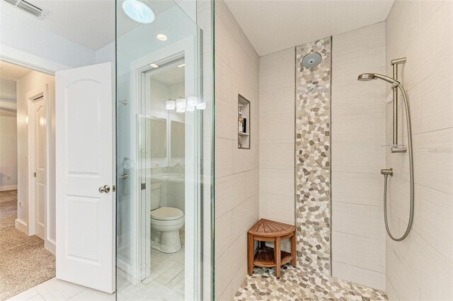 1103 134th St E, Bradenton, FL 34212 - full bathroom featuring tiled shower, toilet, and tile patterned flooring