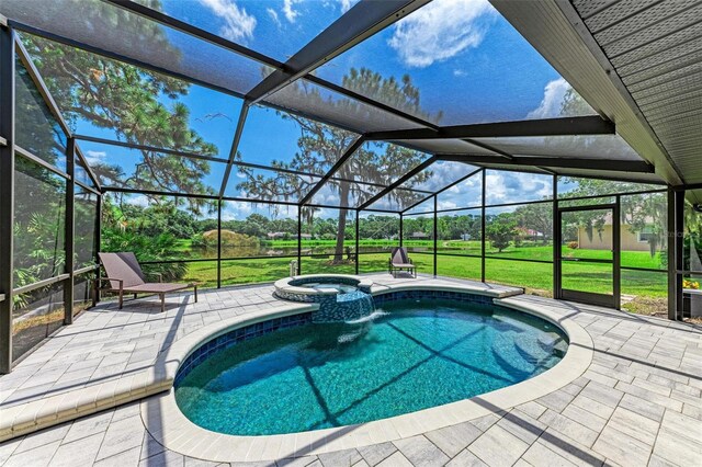 1103 134th St E, Bradenton, FL 34212 - view of swimming pool with a patio area, glass enclosure, a pool with connected hot tub, and a yard