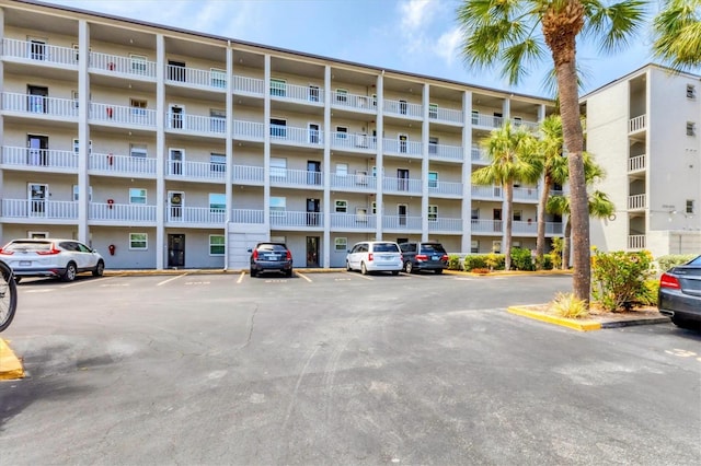 view of building exterior with uncovered parking