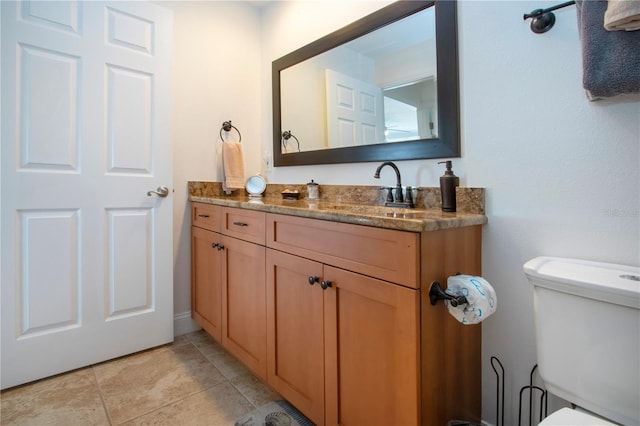 bathroom with tile patterned floors, vanity, and toilet