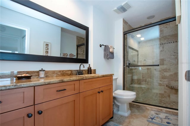 full bath featuring vanity, a stall shower, tile patterned floors, toilet, and visible vents