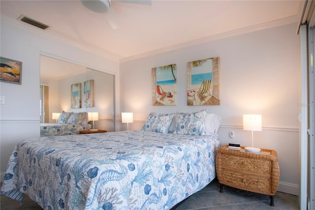 tiled bedroom featuring crown molding, visible vents, and a closet