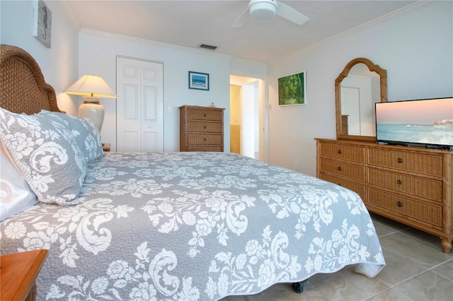 tiled bedroom featuring visible vents, a closet, ornamental molding, and a ceiling fan