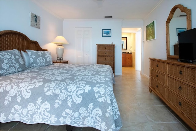 bedroom featuring a closet, light tile patterned flooring, ornamental molding, and visible vents