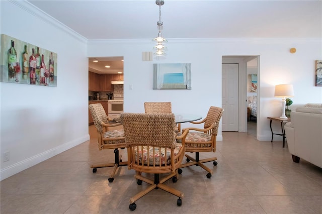 dining room with light tile patterned floors, baseboards, and ornamental molding