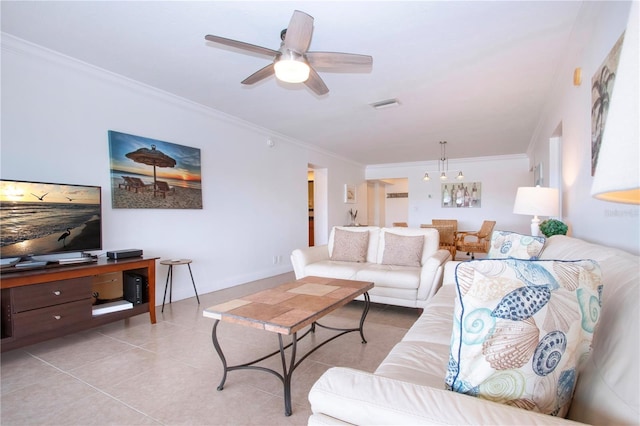 living room featuring ceiling fan with notable chandelier, light tile patterned floors, ornamental molding, and visible vents