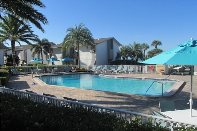 community pool featuring a patio and fence