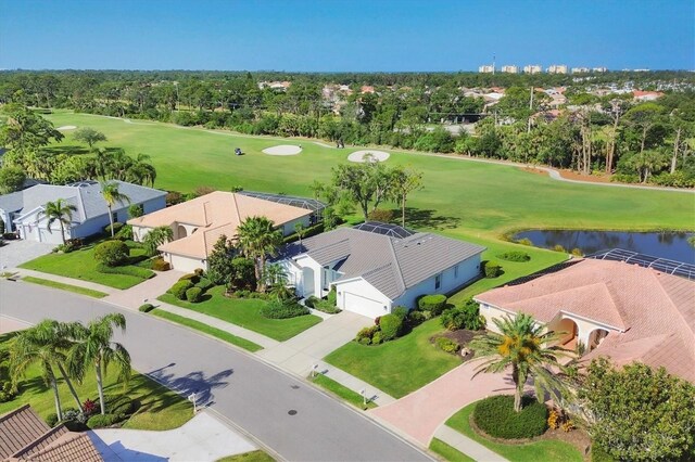 8718 Grey Oaks Ave, Sarasota, FL 34238 - aerial perspective of suburban area with a local golf course, a nearby body of water, and a tree filled landscape