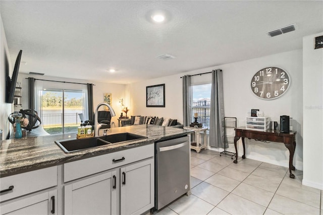 2812 Rock Sound St, Bradenton, FL 34208 - kitchen featuring dishwasher, a sink, plenty of natural light, and baseboards