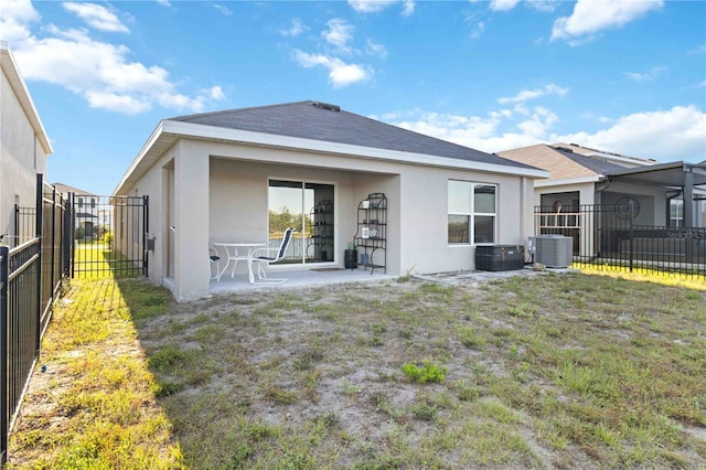 2812 Rock Sound St, Bradenton, FL 34208 - back of house featuring stucco siding, cooling unit, and a patio area