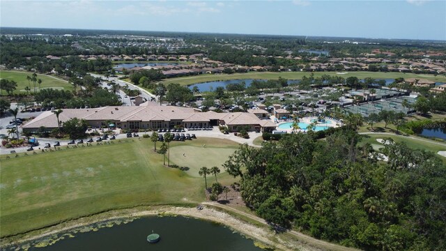 bird's eye view with a water view, view of golf course, and a residential view