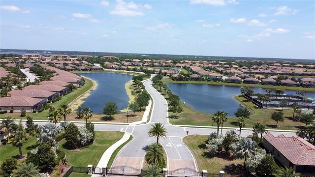 birds eye view of property featuring a water view and a residential view