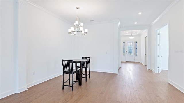 15722 San Lazzaro Ave, Lakewood Ranch, FL 34211 - dining area featuring an inviting chandelier, baseboards, ornamental molding, and wood finished floors