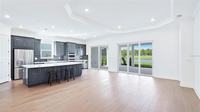 15722 San Lazzaro Ave, Lakewood Ranch, FL 34211 - kitchen with gray cabinets, a large island, light countertops, and stainless steel appliances