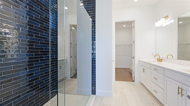 15722 San Lazzaro Ave, Lakewood Ranch, FL 34211 - bathroom featuring a shower stall, double vanity, a sink, and a spacious closet
