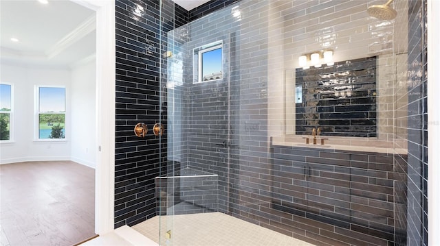 15722 San Lazzaro Ave, Lakewood Ranch, FL 34211 - bathroom featuring tiled shower, wood finished floors, baseboards, and ornamental molding