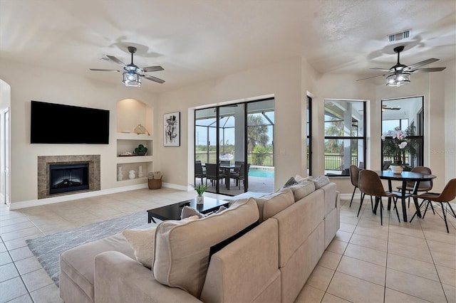 24017 Peppercorn Rd, Punta Gorda, FL 33955 - living area with visible vents, built in shelves, a ceiling fan, and light tile patterned flooring