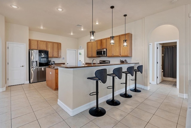 24017 Peppercorn Rd, Punta Gorda, FL 33955 - kitchen with light tile patterned floors, a peninsula, dark countertops, visible vents, and appliances with stainless steel finishes