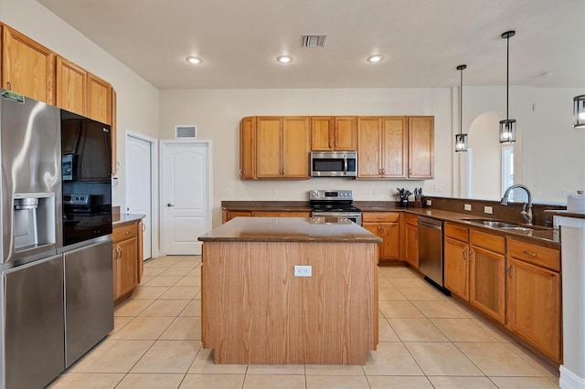 24017 Peppercorn Rd, Punta Gorda, FL 33955 - kitchen with light tile patterned flooring, a kitchen island, a sink, and stainless steel appliances