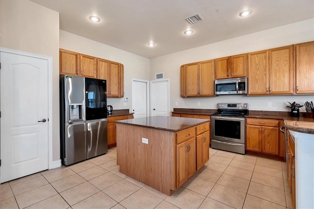 24017 Peppercorn Rd, Punta Gorda, FL 33955 - kitchen featuring visible vents, a kitchen island, light tile patterned floors, and stainless steel appliances