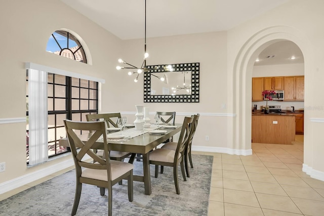 24017 Peppercorn Rd, Punta Gorda, FL 33955 - dining room featuring arched walkways, light tile patterned floors, baseboards, and an inviting chandelier