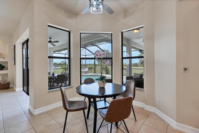 24017 Peppercorn Rd, Punta Gorda, FL 33955 - dining space featuring a sunroom, baseboards, a ceiling fan, and light tile patterned floors