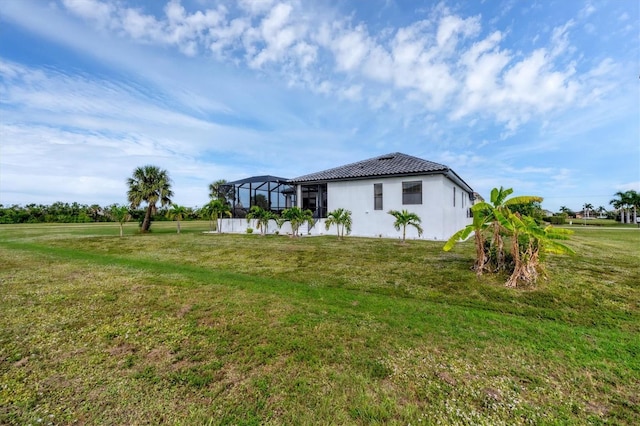 24017 Peppercorn Rd, Punta Gorda, FL 33955 - view of side of home featuring a lanai, a yard, stucco siding, and a tile roof