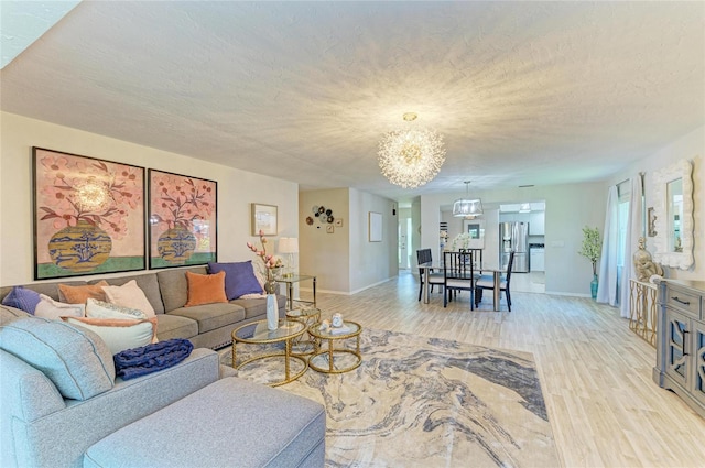 1622 Stafford Ln Unit 1205, Sarasota, FL 34232 - living area with light wood-style flooring, baseboards, and a chandelier