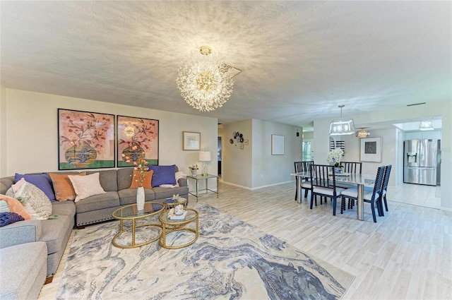 1622 Stafford Ln Unit 1205, Sarasota, FL 34232 - living room with baseboards, a chandelier, and light wood-style flooring