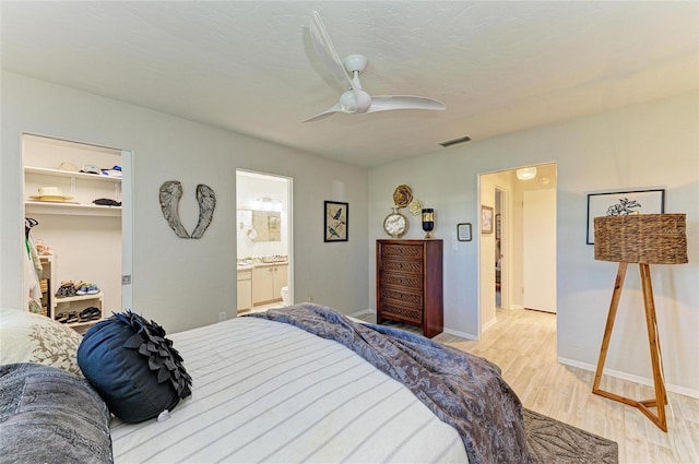1622 Stafford Ln Unit 1205, Sarasota, FL 34232 - bedroom featuring a ceiling fan, a spacious closet, light wood-style floors, baseboards, and visible vents