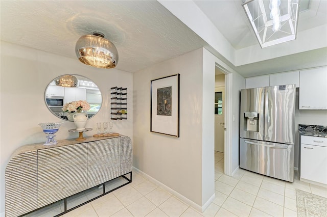 1622 Stafford Ln Unit 1205, Sarasota, FL 34232 - corridor featuring baseboards, a notable chandelier, and light tile patterned floors