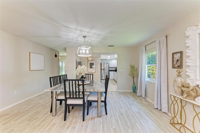 1622 Stafford Ln Unit 1205, Sarasota, FL 34232 - dining space featuring baseboards and light wood-style flooring