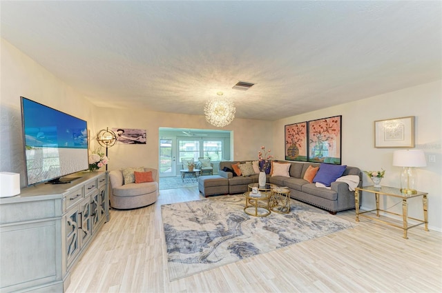 1622 Stafford Ln Unit 1205, Sarasota, FL 34232 - living room featuring light wood-type flooring, visible vents, and a notable chandelier