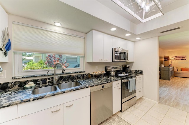 1622 Stafford Ln Unit 1205, Sarasota, FL 34232 - kitchen with visible vents, dark stone countertops, stainless steel appliances, and a sink