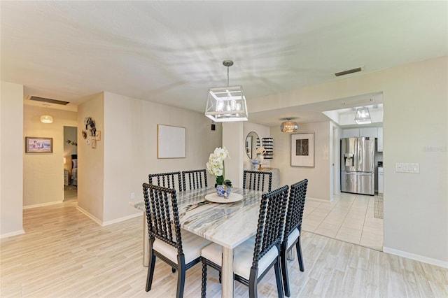 1622 Stafford Ln Unit 1205, Sarasota, FL 34232 - dining area with light wood-style flooring, visible vents, and baseboards