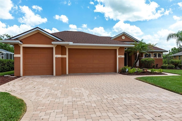 single story home featuring an attached garage, decorative driveway, and stucco siding