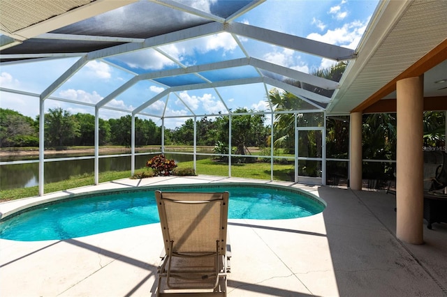 pool with a water view, a patio area, and a lanai
