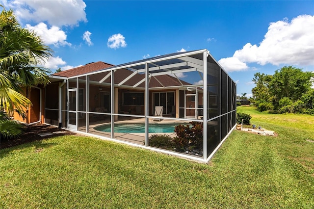 rear view of house featuring a yard, an outdoor pool, and a patio area
